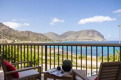 a balcony with a view of the ocean and mountains at Sole di Giada by DomuSicily in Mondello