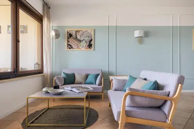 a living room with a couch and a table at Sole di Giada by DomuSicily in Mondello