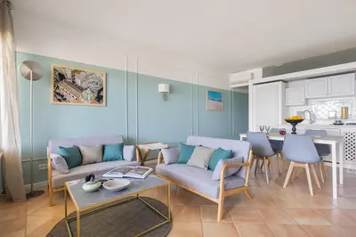 a living room with a couch and a table at Sole di Giada by DomuSicily in Mondello