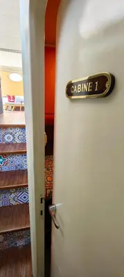 a room with a door with a sign on it at Panaby - House Boat in Palermo