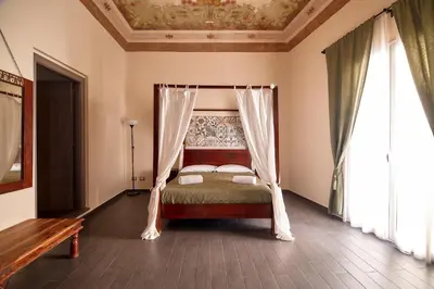 a bedroom with a bed with a canopy at La Terrazza sul Centro in Palermo