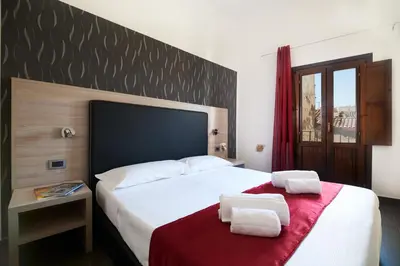 a bedroom with a bed with two towels on it at La Terrazza sul Centro in Palermo