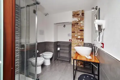 a bathroom with two toilets and a glass shower at La Terrazza sul Centro in Palermo