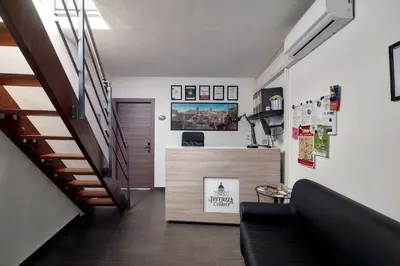 a living room with a staircase and a stair case at La Terrazza sul Centro in Palermo