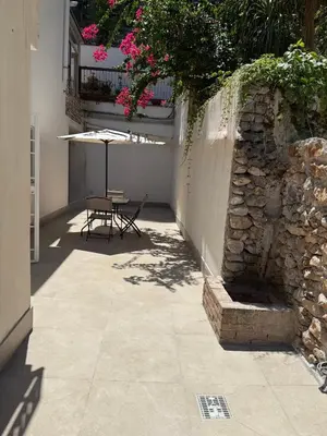 a patio with a table and an umbrella at Porta Addaura in Palermo