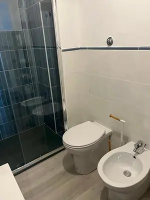a bathroom with a toilet and a shower and a sink at Porta Addaura in Palermo
