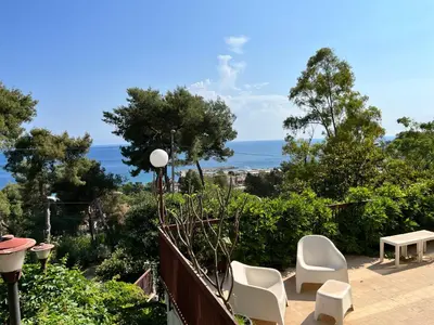 a balcony with two chairs and a view of the ocean at Porta Addaura in Palermo