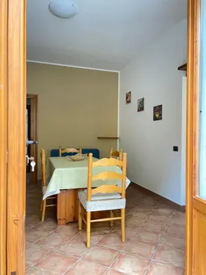 a dining room with a table and a chair at La Capinera Holidays in Santa Flavia