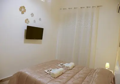 a bedroom with a bed with two towels on it at Case Saniela in Terrasini