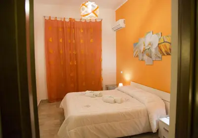 a bedroom with a bed with two towels on it at Case Saniela in Terrasini