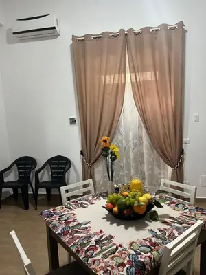 a dining room table with a bowl of fruit on it at Casa Corbezzolo in Balestrate