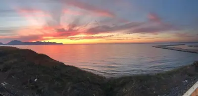 a sunset over a body of water with at Casa Corbezzolo in Balestrate