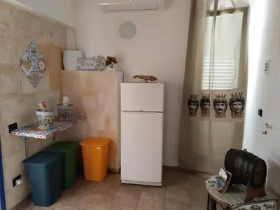 a small kitchen with a white refrigerator and a window at B&B Sikelia in Terrasini