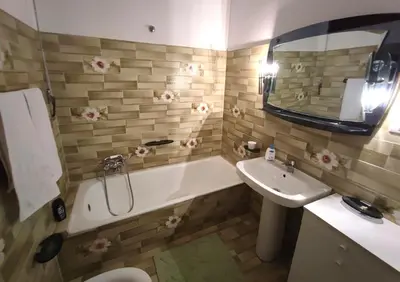 a bathroom with a tub and a sink and a bath tub at Dai Maestri Rubino in Vita