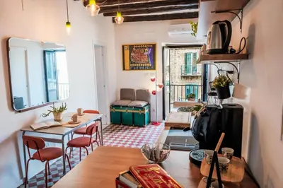 a living room with a table and chairs and a room with a table sidx sidx at caZÁ ~ Palermo in Palermo