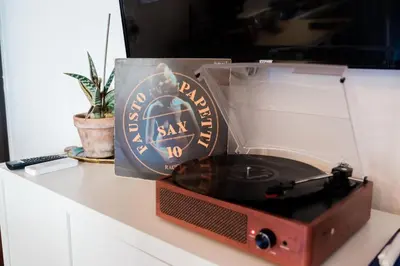 an old radio sitting on a counter with a vinyl record at caZÁ ~ Palermo in Palermo