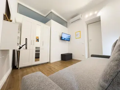 a bedroom with a bed and a couch at caZÁ ~ Palermo in Palermo