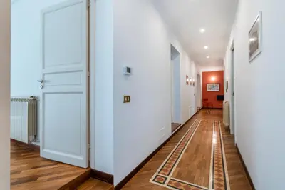 a hallway with white doors and wooden floors at Casa Bentivegna in Palermo