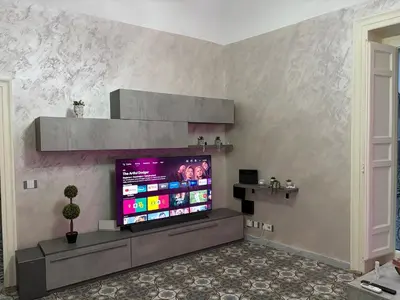 a living room with a large flat screen tv at Elisir house in Palermo