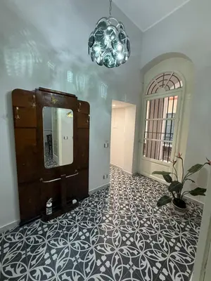 a room with a large mirror and a potted plant at Elisir house in Palermo