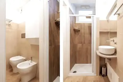 a bathroom with a toilet and a sink and a shower at Loft Vetriera in Palermo
