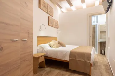 a small bedroom with a bed and a closet at Loft Vetriera in Palermo