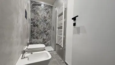 a bathroom with a toilet and a sink and a shower at Suites Masculu & Fimmina in Palermo