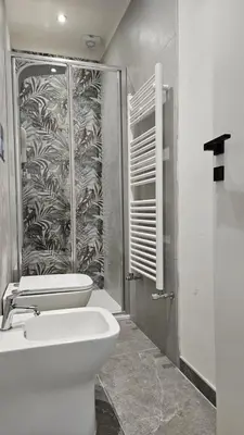 a bathroom with a toilet and a shower and a sink at Suites Masculu & Fimmina in Palermo
