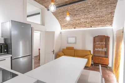 a kitchen and living room with a couch and a refrigerator at Calderai 82 suites 1 e 2 in Palermo