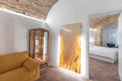 a living room with a couch and a bed at Calderai 82 suites 1 e 2 in Palermo