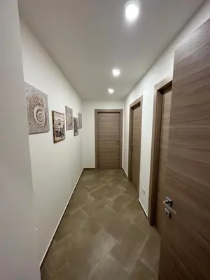 a hallway with a door and a tile floor at Gravina in Trappeto