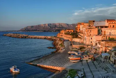 a group of boats are docked in the water at Gravina in Trappeto
