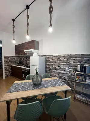 a kitchen with a table and chairs with a vase on it at Tiny house in Palermo