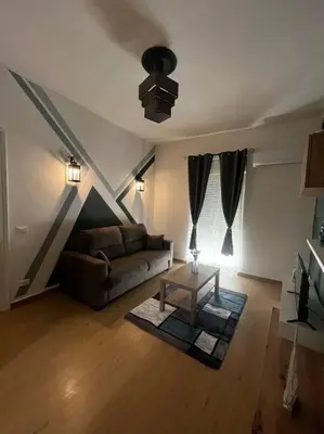 a living room with a couch and a table at Tiny house in Palermo