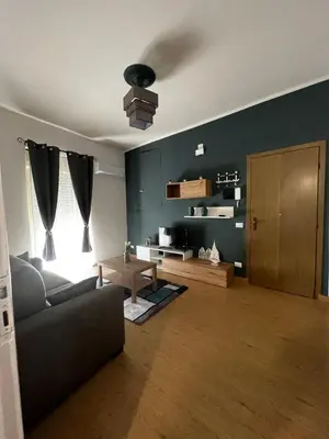 a living room with a couch and a table at Tiny house in Palermo