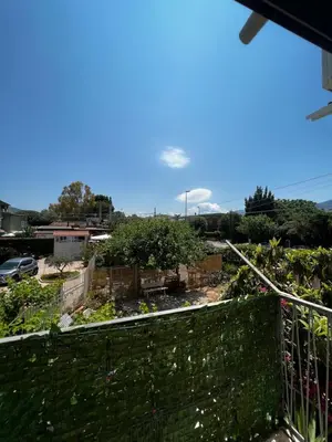 a view of a garden from a balcony at Tiny house in Palermo
