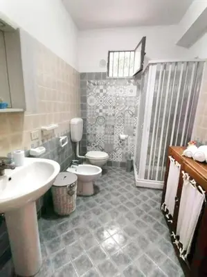 a bathroom with a sink and a toilet and a shower at Casa Tequi a 200mt dal mare in Terrasini