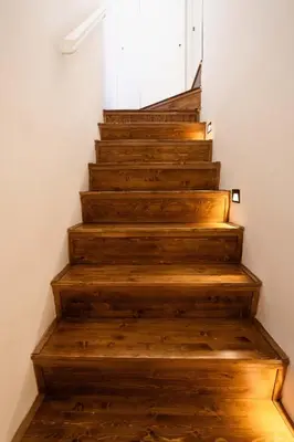 a staircase with wooden floors and a white door at Le Terrazze dei Candelai 
