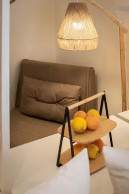 a table with a shelf with lemons and a lamp at Le Terrazze dei Candelai 