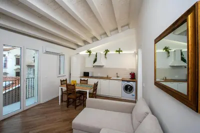 a living room with a couch and a table at Cortile Del Greco Apartments in Palermo