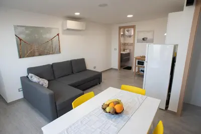 a living room with a couch and a table with fruit on it at Appartamento con terrazza in Isola delle Femmine
