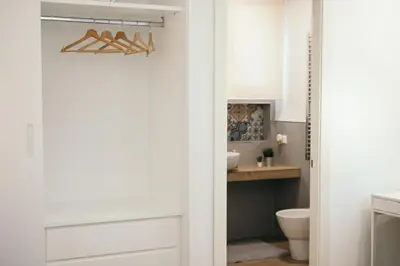 a bathroom with a door leading into a bathroom with a sink at La Casa di Ale in Palermo