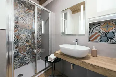 a bathroom with a sink and a shower at La Casa di Ale in Palermo
