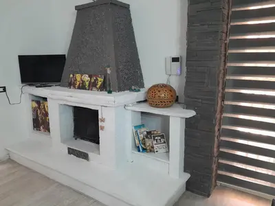 a fireplace in a living room next to a staircase at Sea Holiday Orchidea in Palermo