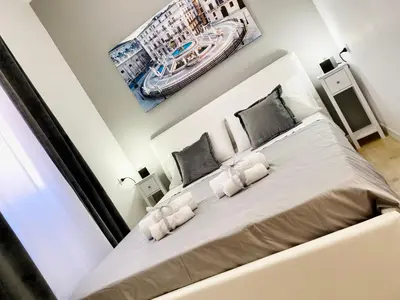 a bedroom with a large white bed with two pillows at Affittacamere Palermo Pirri in Palermo