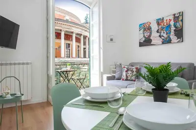 a living room with a table and a couch at The house Politeama Palermo Historic center in Palermo