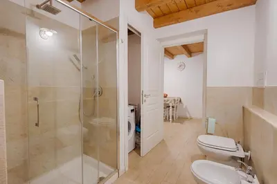 a bathroom with a glass shower and a toilet at GuestHost - Il Piccolo Scrigno - Functional & Central Studio in Castellammare del Golfo