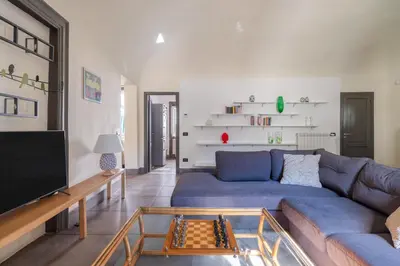 a living room with a blue couch and a tv at Palazzo Sant'Agostino in Palermo