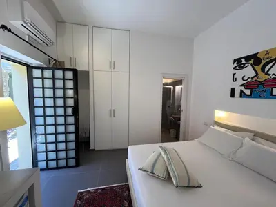 a bedroom with a white bed and white cabinets at Palazzo Sant'Agostino in Palermo