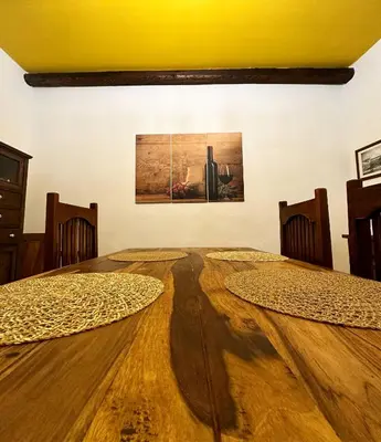 a dining room with a table and a painting on the wall at Cut' Home in Monreale